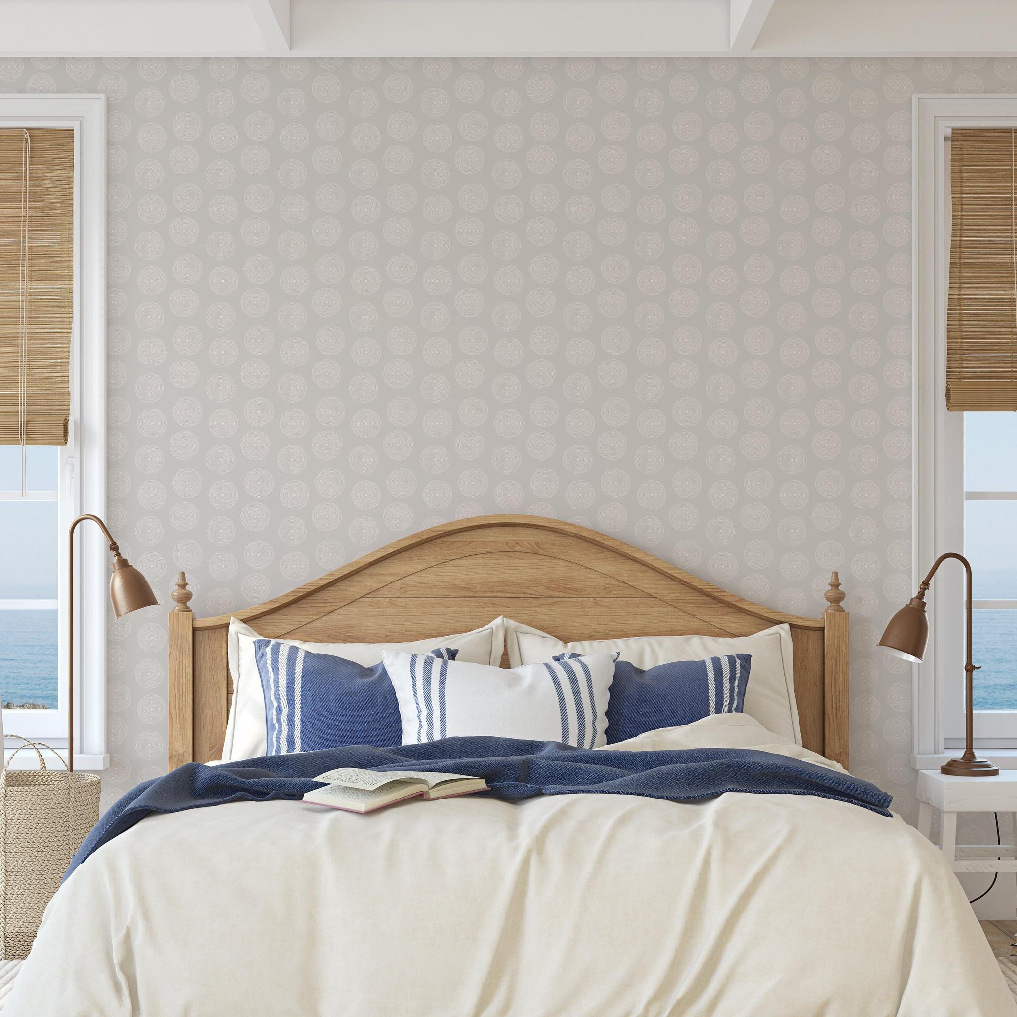 Wall Blush's Sand Dollar Wallpaper in a coastal bedroom setting, highlighting the elegance and serene design.
