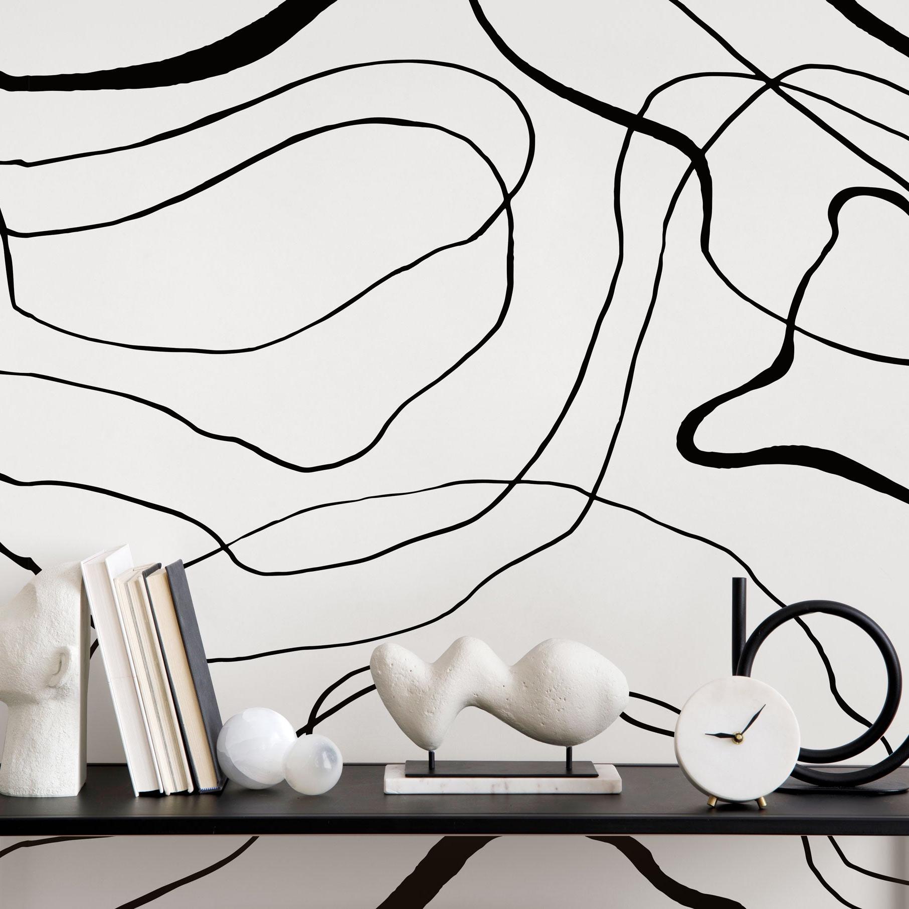 Belmore patterned Wall Blush AW01 wallpaper in a modern room with stylish decor and artistic accents.
