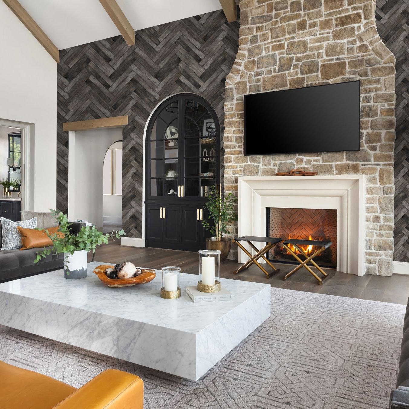 Country Roads Wallpaper by The Tamra Judge Line in a stylish living room with herringbone accent wall focus.
