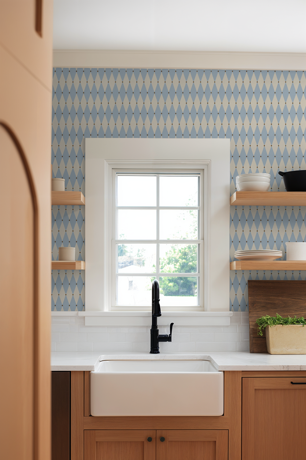 Aqua argyle wallpaper in a modern kitchen with wooden shelves and a farmhouse sink.