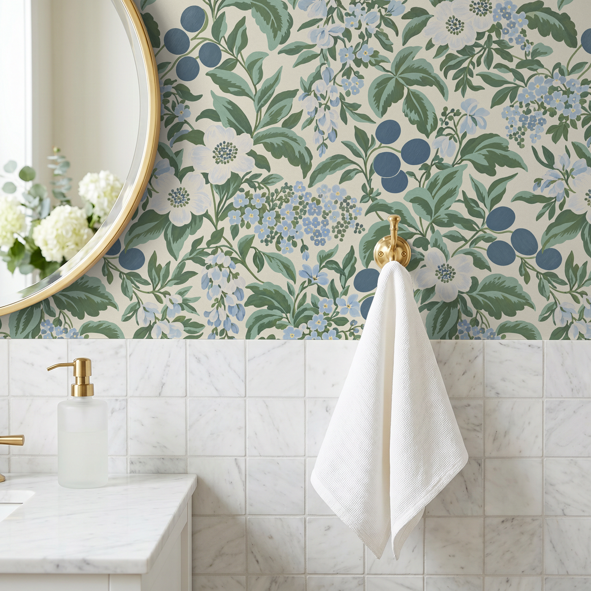 Bloomique Sage and Berry floral wallpaper in bathroom with marble tiles and gold fixtures.