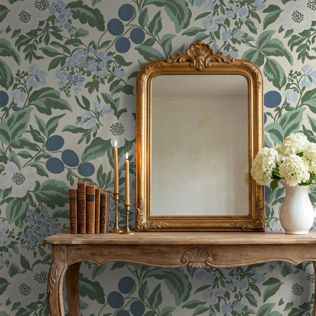Bloomique Sage and Berry floral wallpaper with powdery blues and greens behind an ornate mirror and wooden table.
