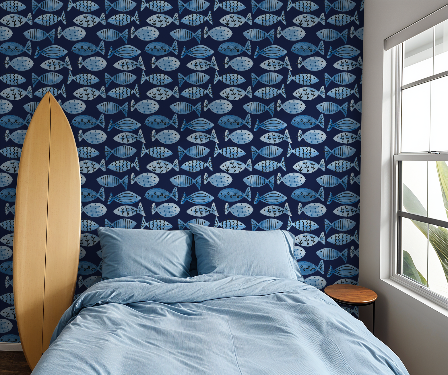 Blue fish pattern wallpaper on navy background in coastal bedroom with surfboard.