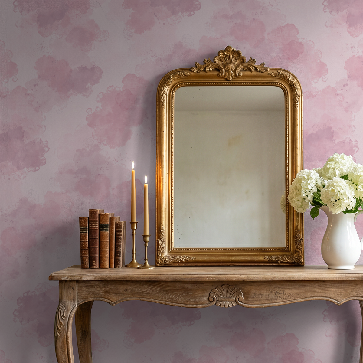 Blush pink watercolor cloud wallpaper in elegant room with mirror and flowers.