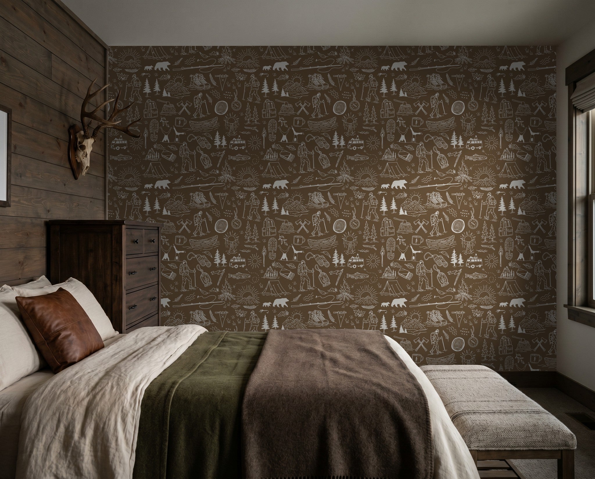 Brown adventure-themed wallpaper with white sketches in rustic bedroom setting.
