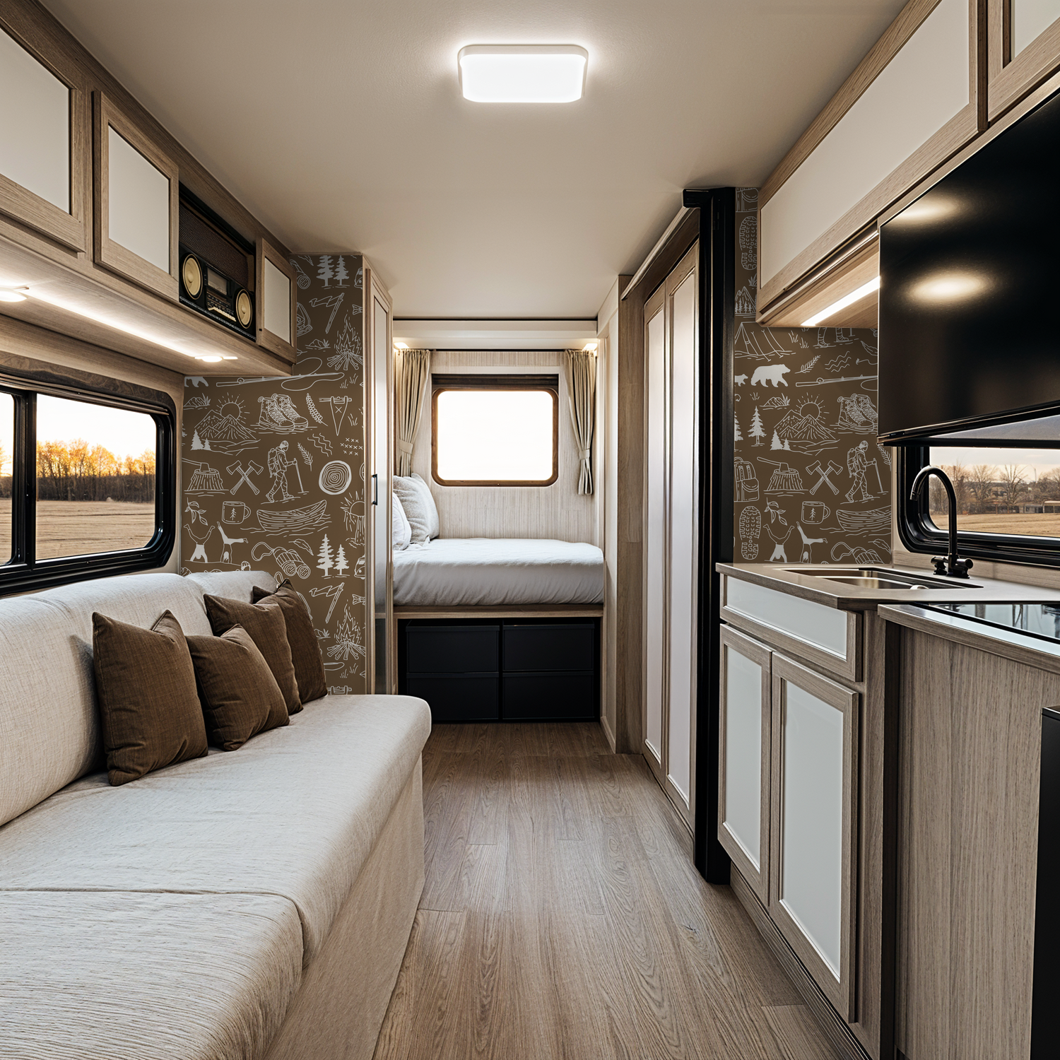 Brown adventure-themed wallpaper with white sketches in RV interior.