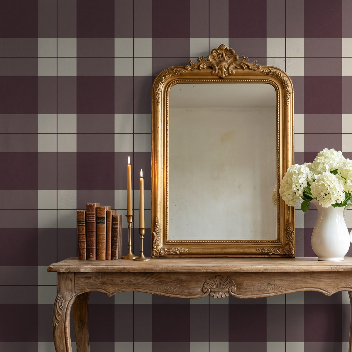 Burgundy plaid wallpaper in elegant room with ornate mirror and candles.