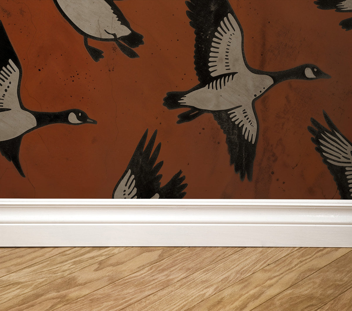 Crimson wallpaper with black and white flying geese, wooden floor, white baseboard.