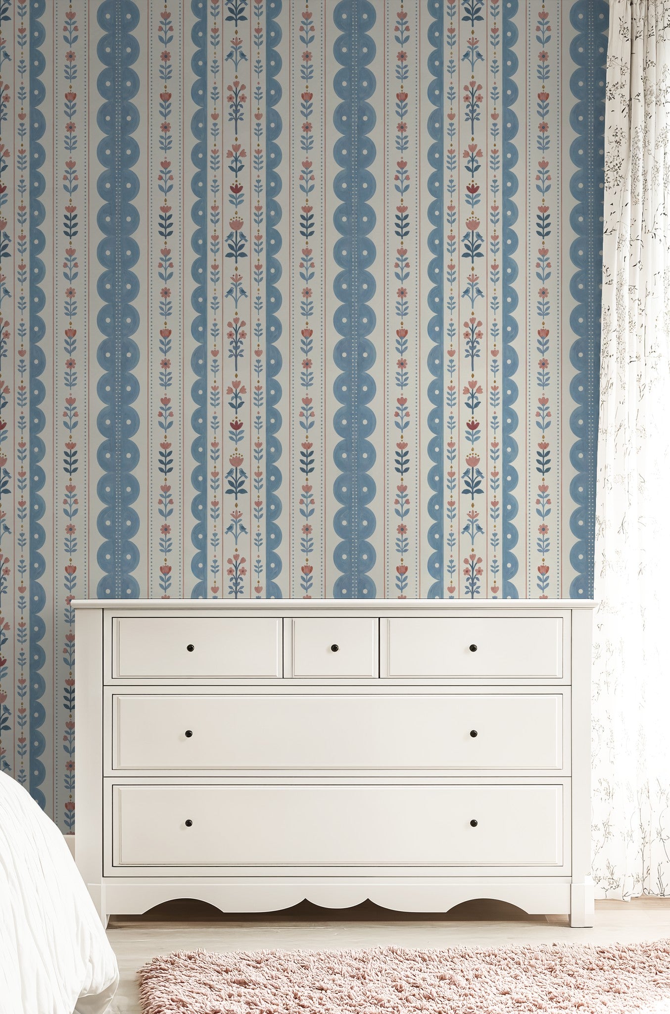 Dahlia Dreams wallpaper with blue and coral floral stripes in a bedroom with white dresser.