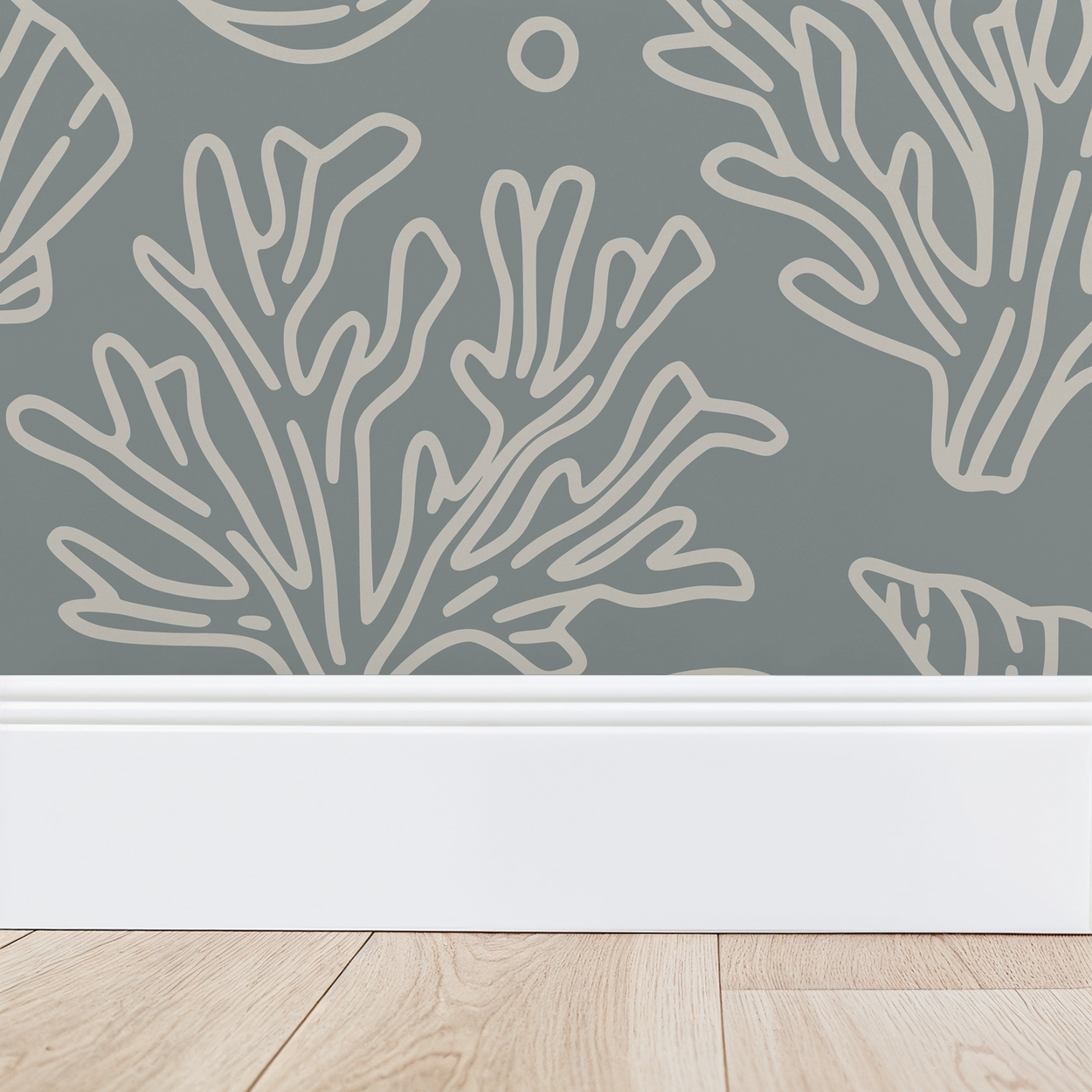 Dusty blue wallpaper with white coral and seashell design above white baseboard.
