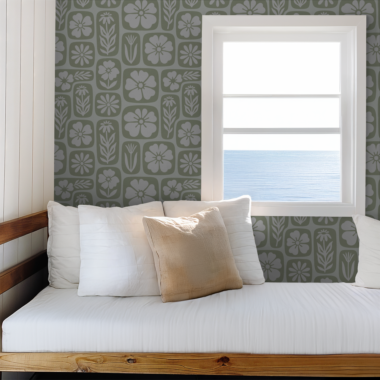 Floral sage green wallpaper in cozy room with ocean view window and white bedding.