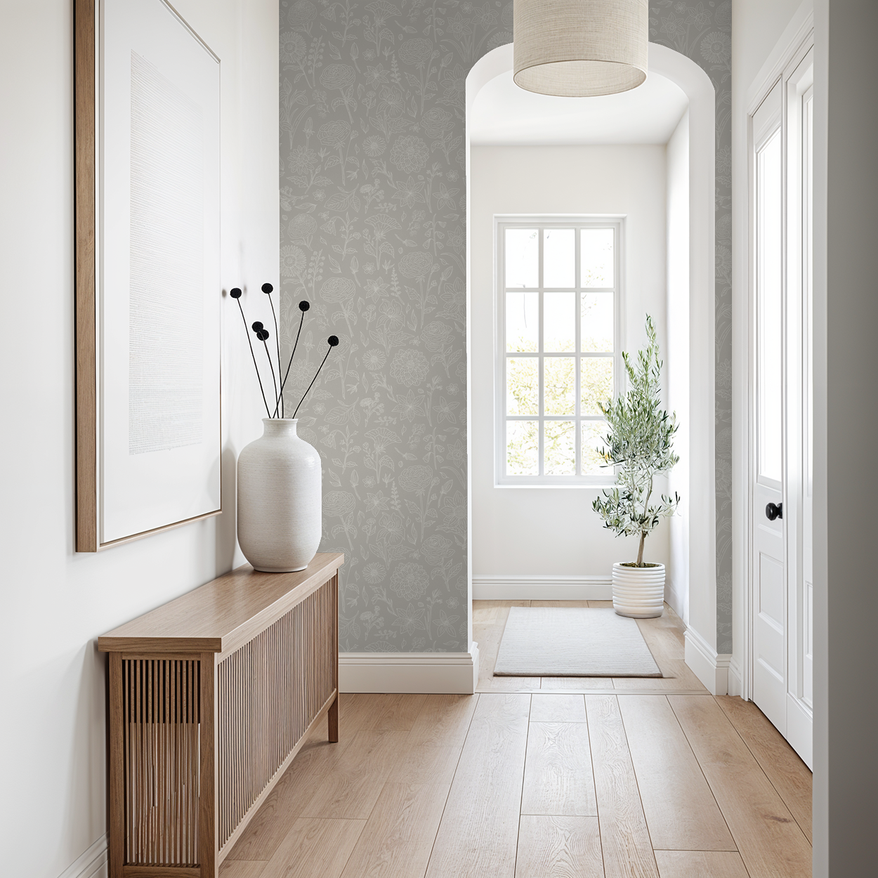 Gray floral wallpaper in a bright hallway with wooden furniture and decor.