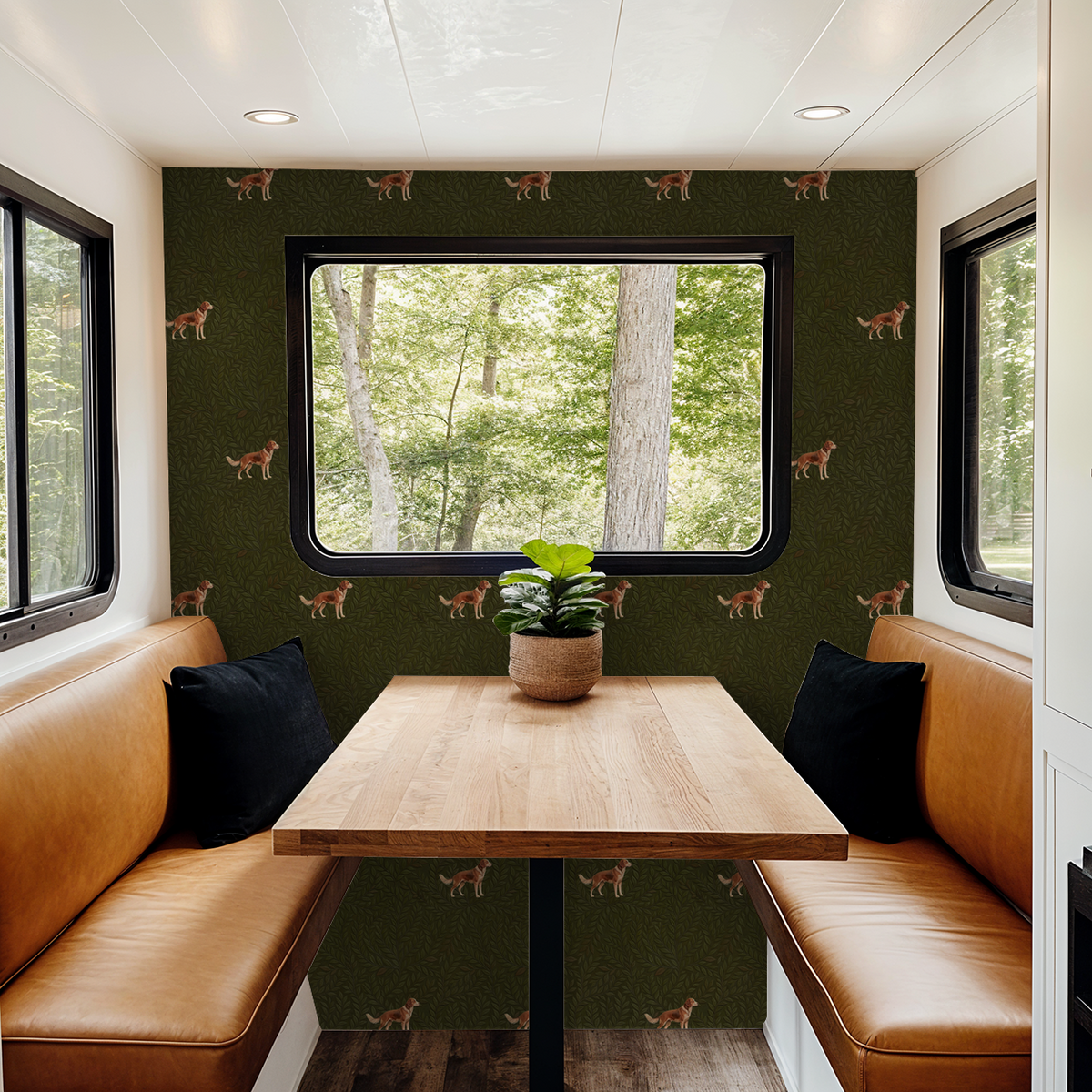 Green wallpaper with dog pattern in cozy dining nook with leather seating.