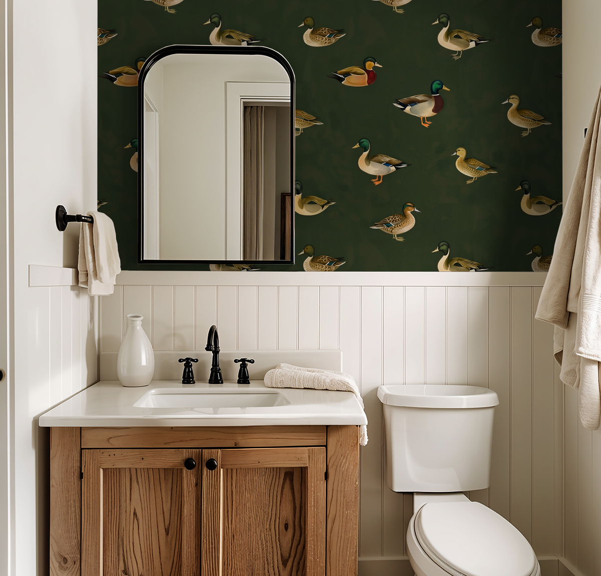 Bathroom with green duck wallpaper, wood vanity, and white wainscoting.