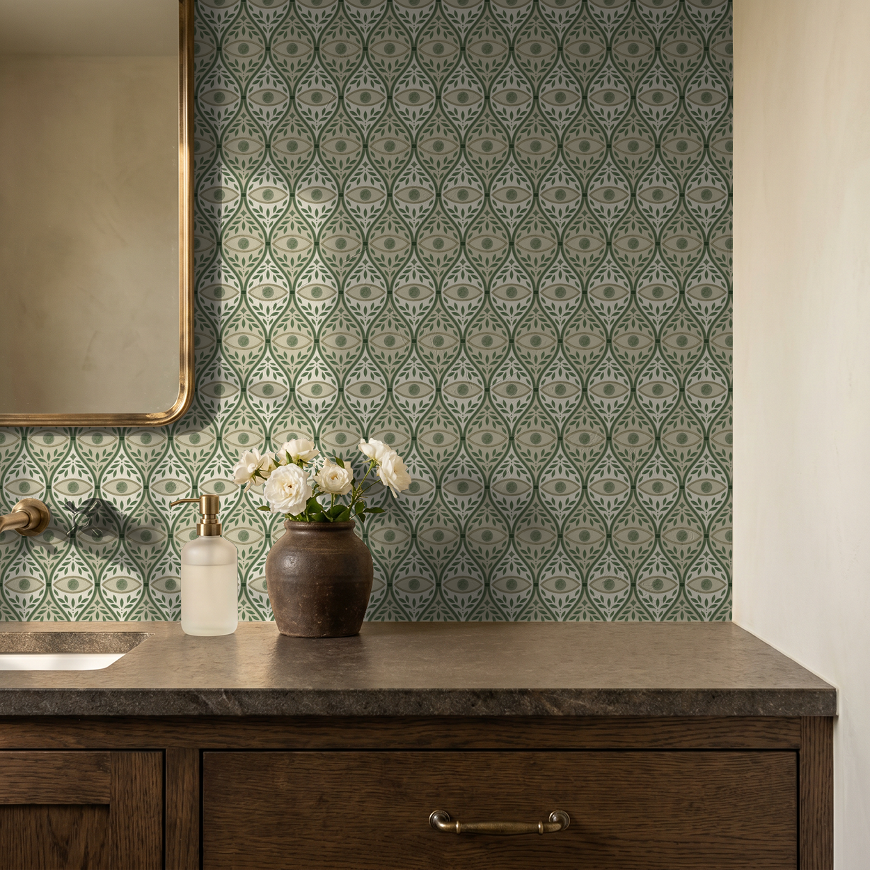 Green geometric patterned wallpaper in bathroom with wooden vanity and flowers.