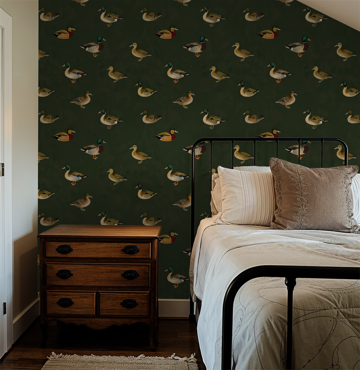 Green wallpaper with illustrated mallard ducks in cozy bedroom setting.