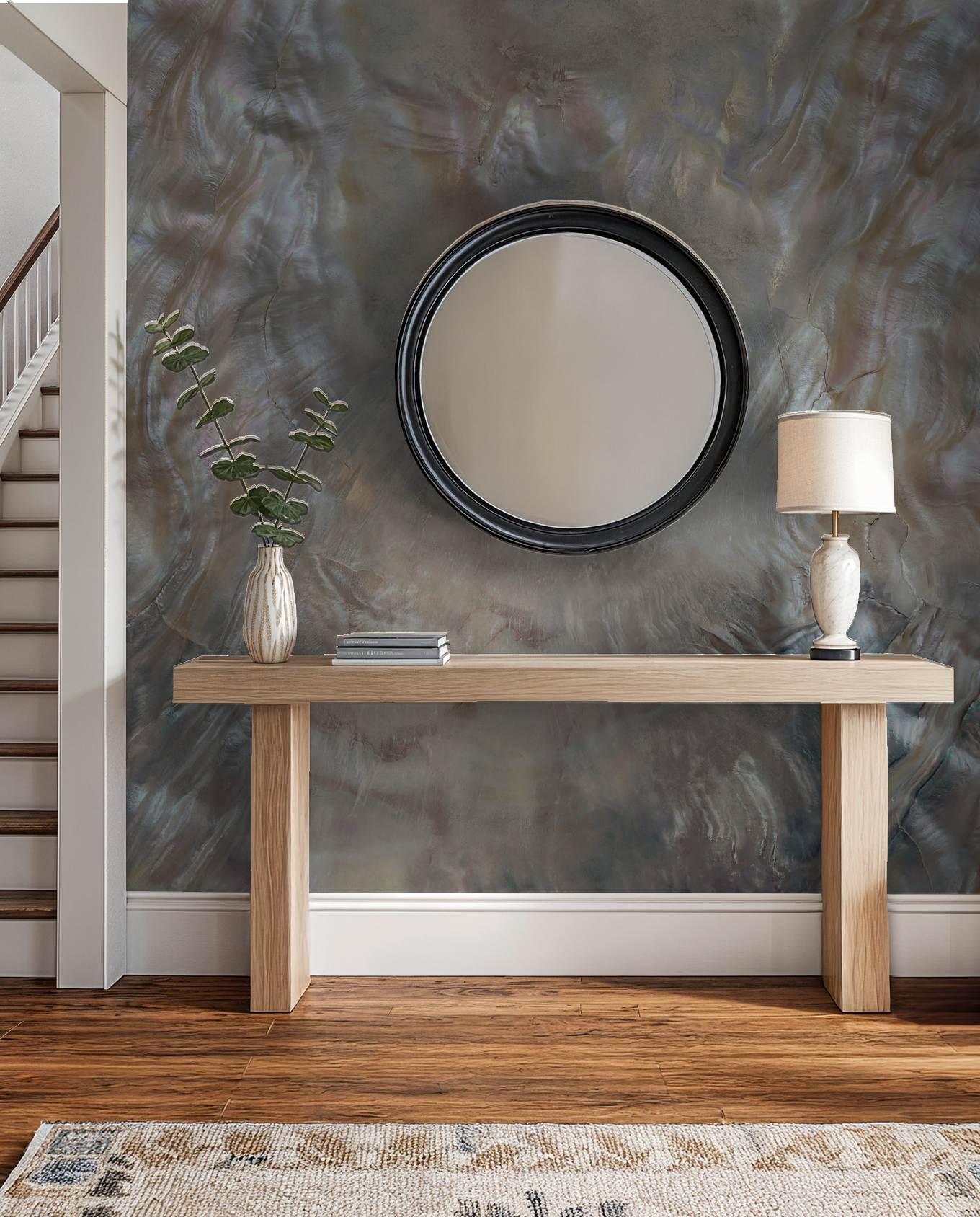 Iridescent textured wallpaper in elegant entryway with wooden console and round mirror.