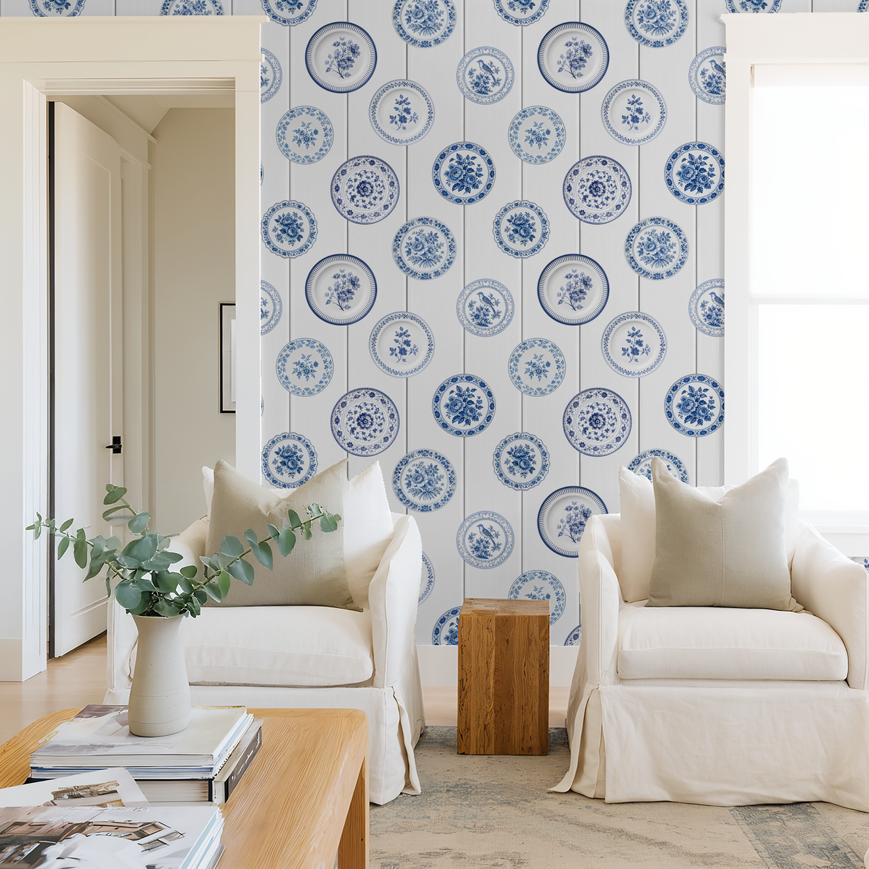 Maison Blue wallpaper with vintage blue porcelain plates in cozy living room setting.