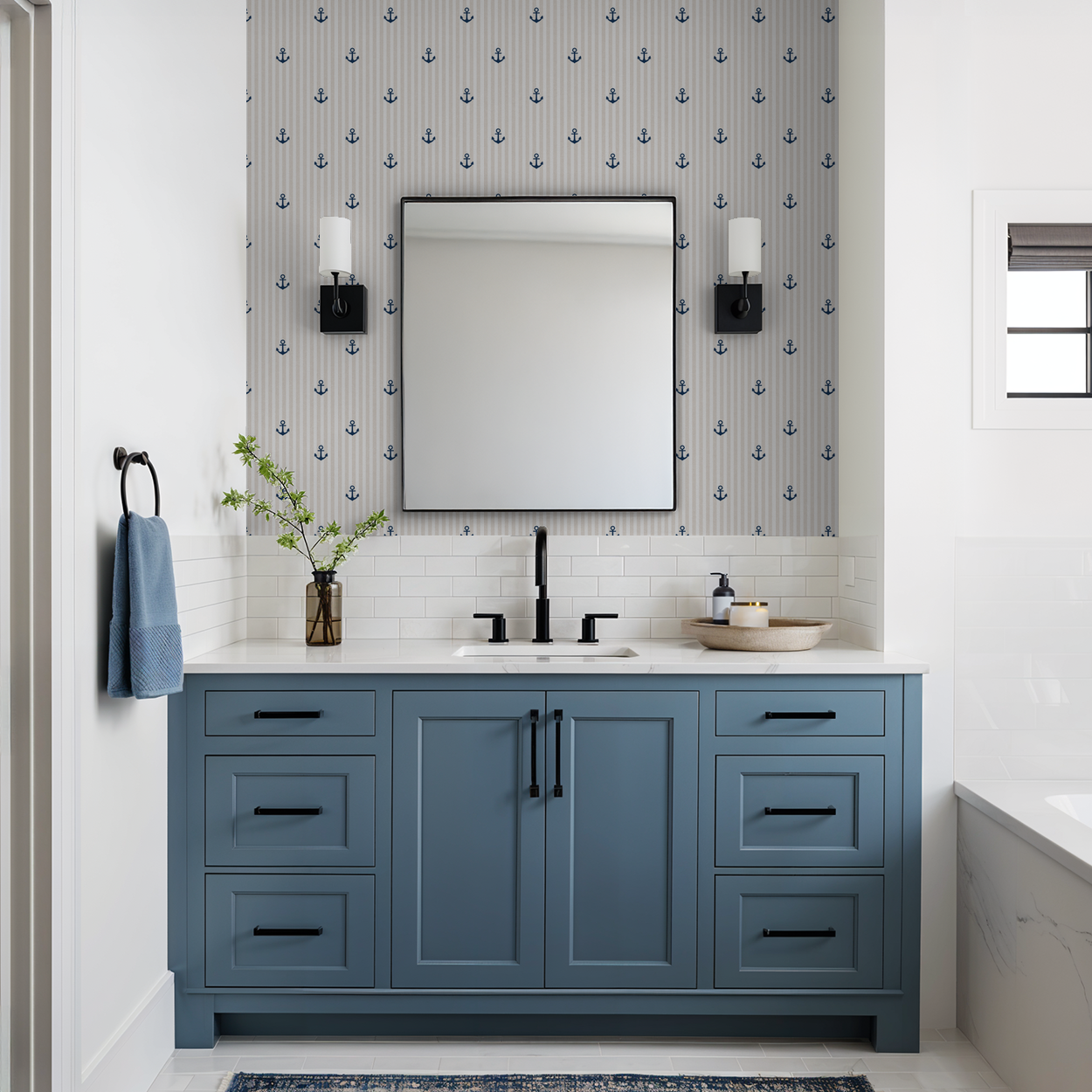 Nautical anchor wallpaper in tan and white stripes in a modern bathroom with blue vanity.