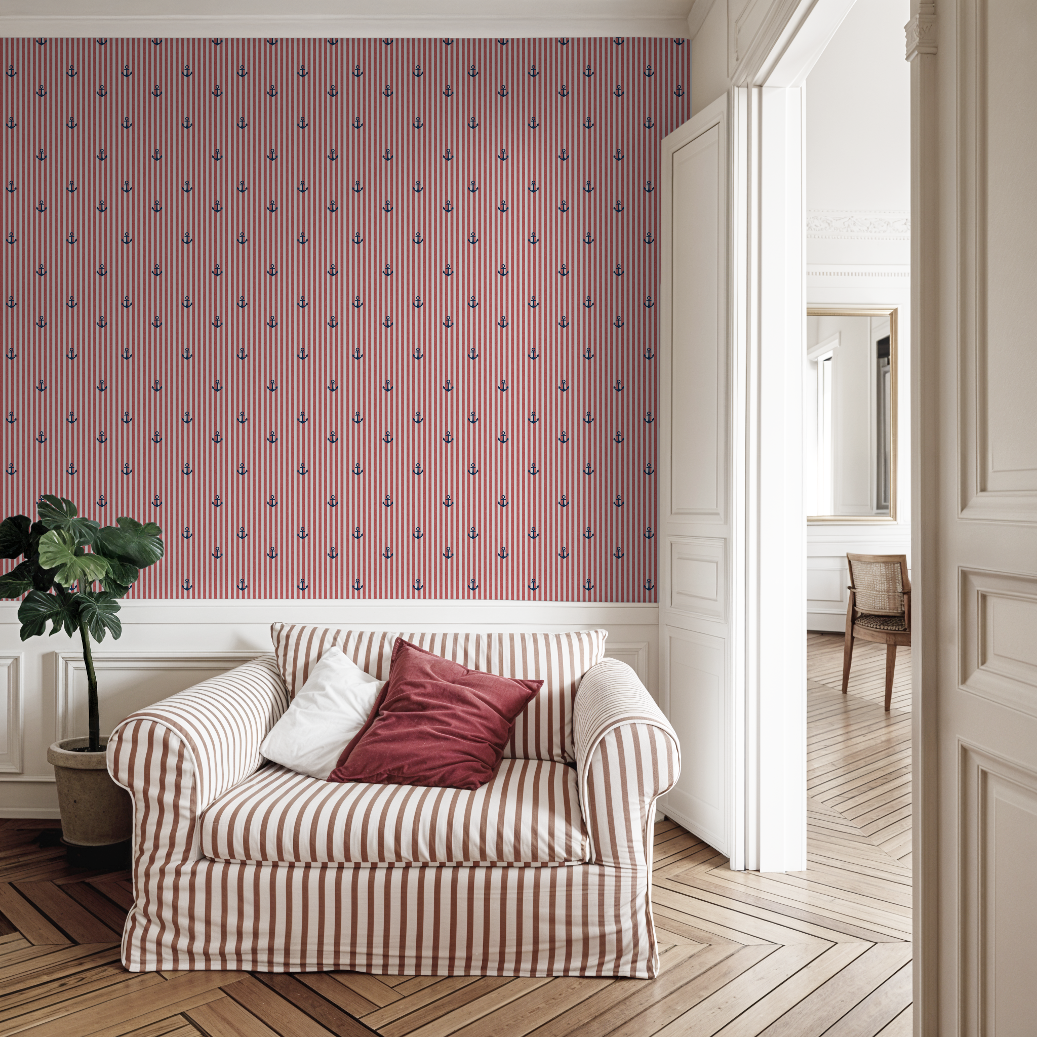 Nautical red striped wallpaper with blue anchors in cozy living room.
