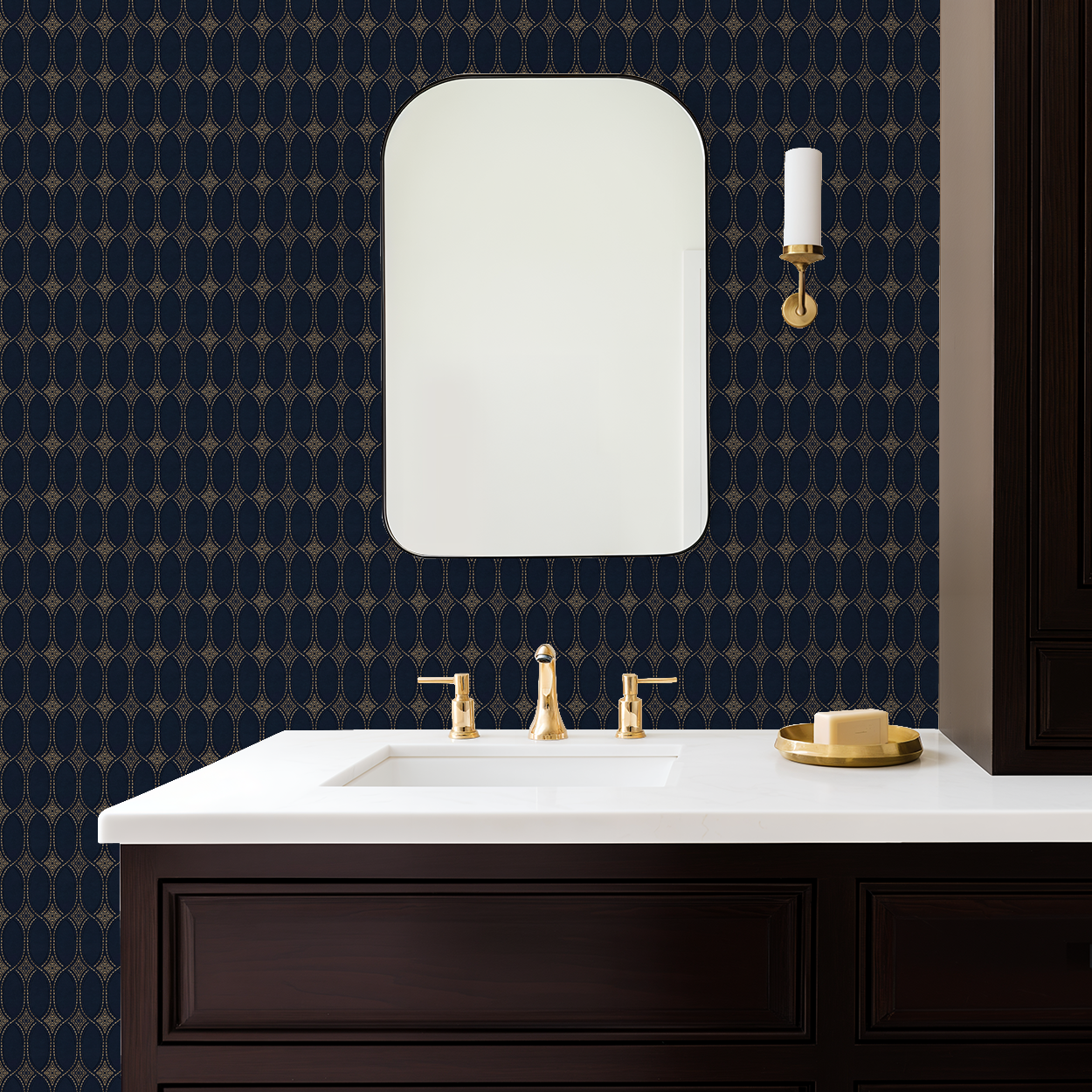 Navy and gold geometric wallpaper in elegant bathroom with mirror and gold fixtures.