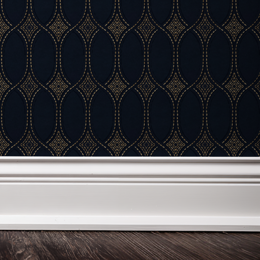 Navy and gold geometric patterned wallpaper with white baseboard