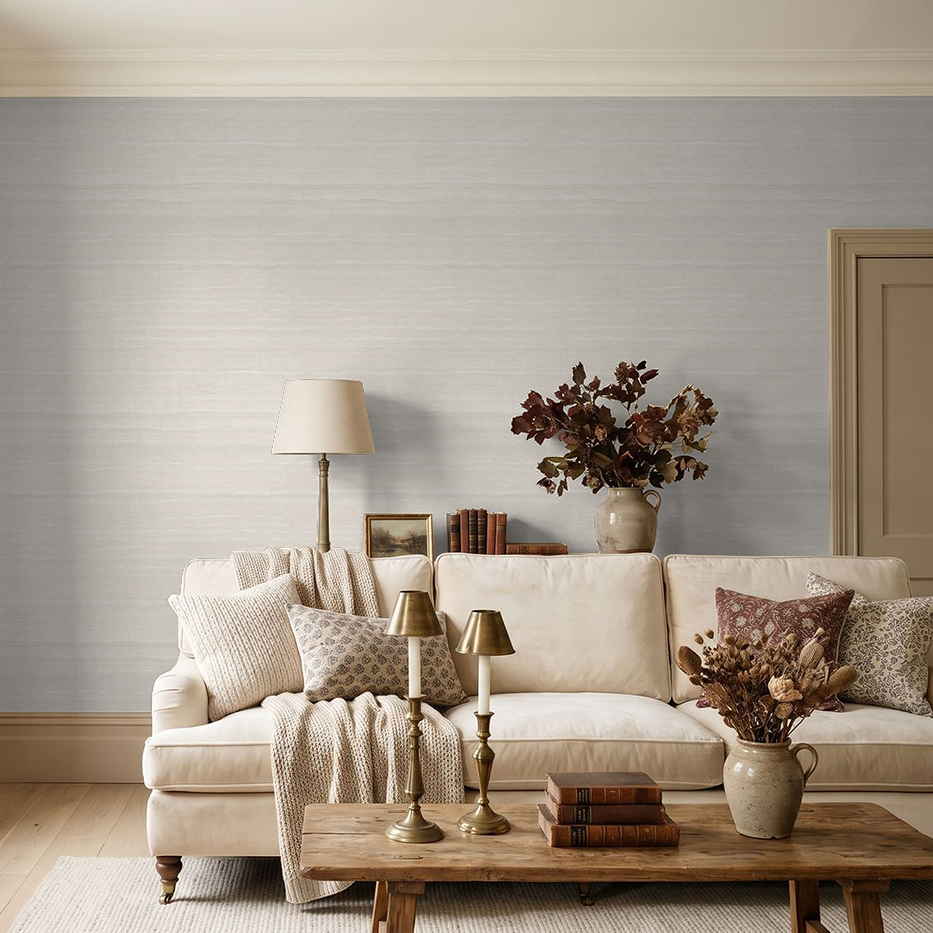Neutral textured wallpaper in cozy living room with beige sofa and wooden accents.