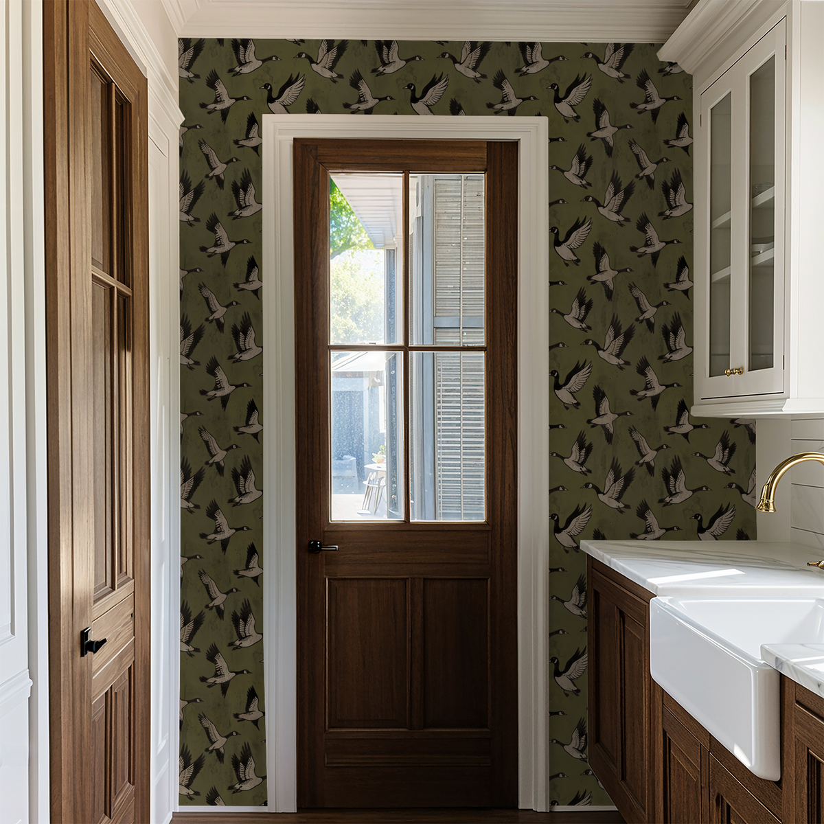 Olive green wallpaper with bird silhouettes in a rustic kitchen setting.