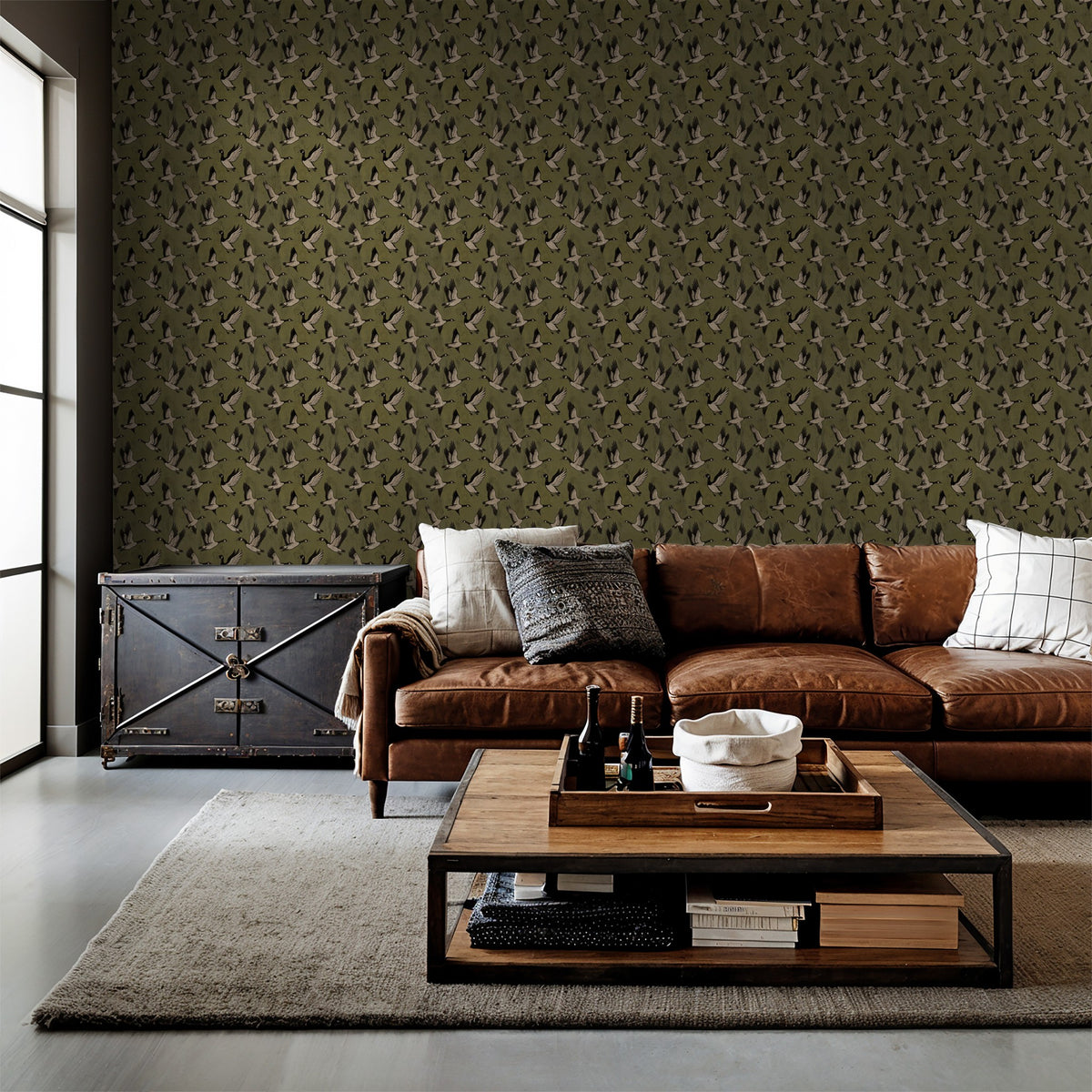Olive green bird silhouette wallpaper in rustic living room with leather sofa.