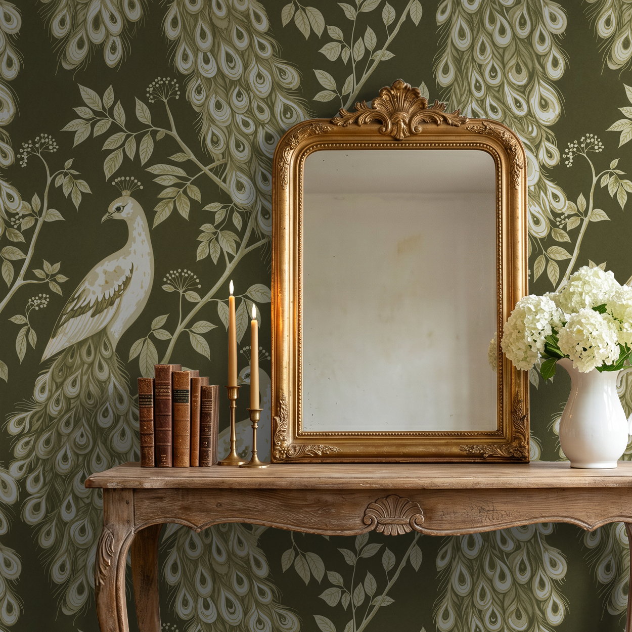 Elegant olive-green wallpaper with ivory peacocks and foliage behind ornate mirror and table.