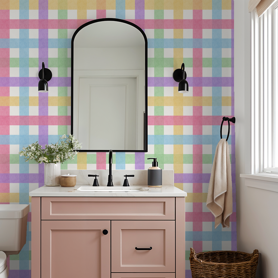Pastel gingham wallpaper in bathroom with pink vanity and black accents.