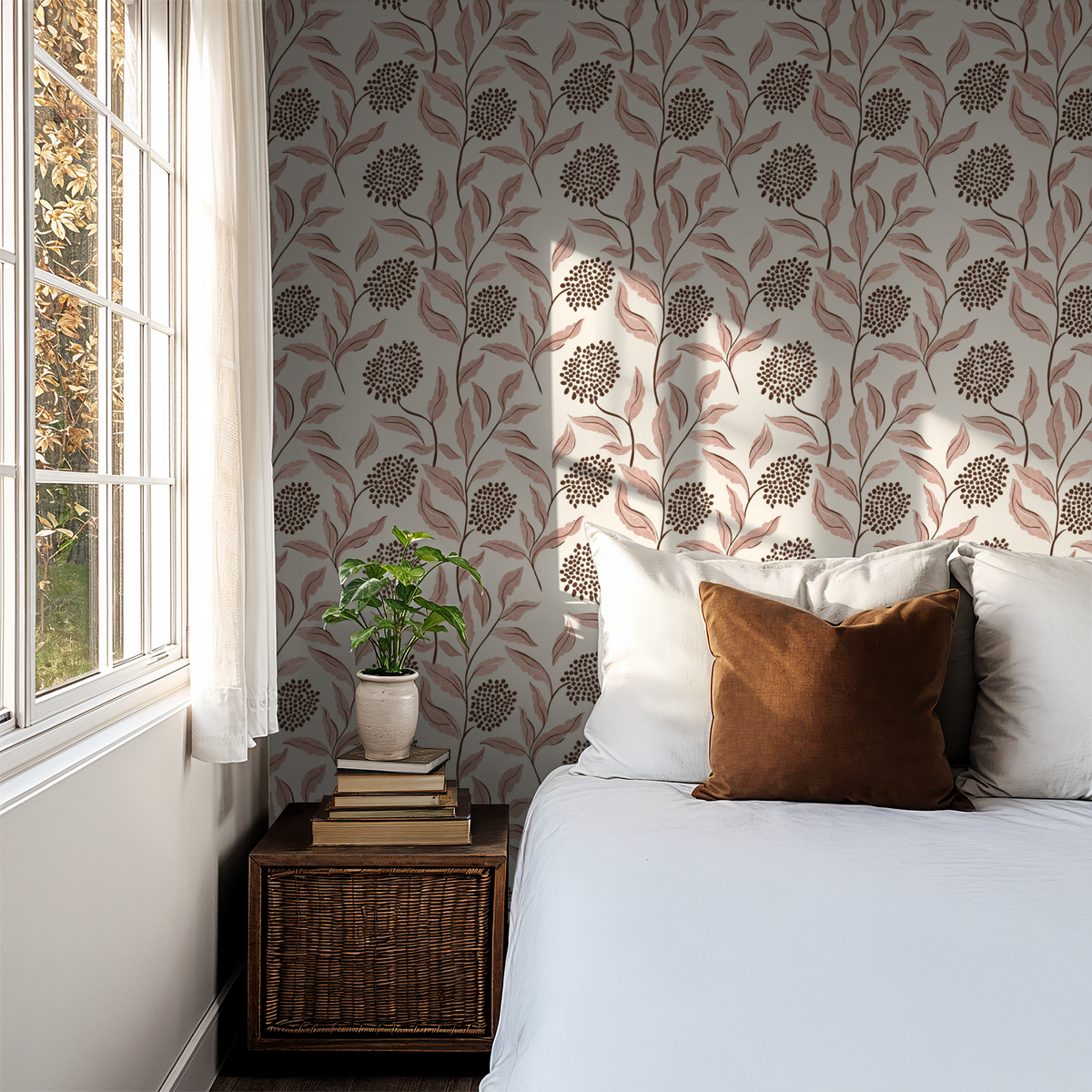 Pink botanical wallpaper with leaves and berries in a cozy bedroom setting.