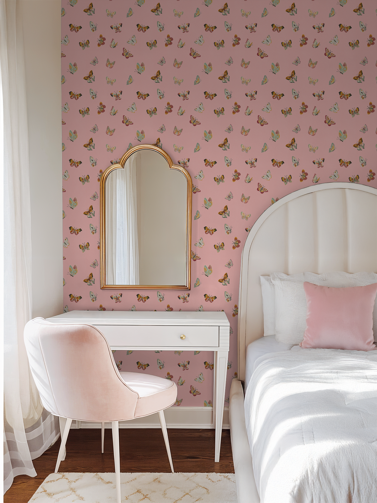Pink butterfly wallpaper in bedroom with white desk and chair.
