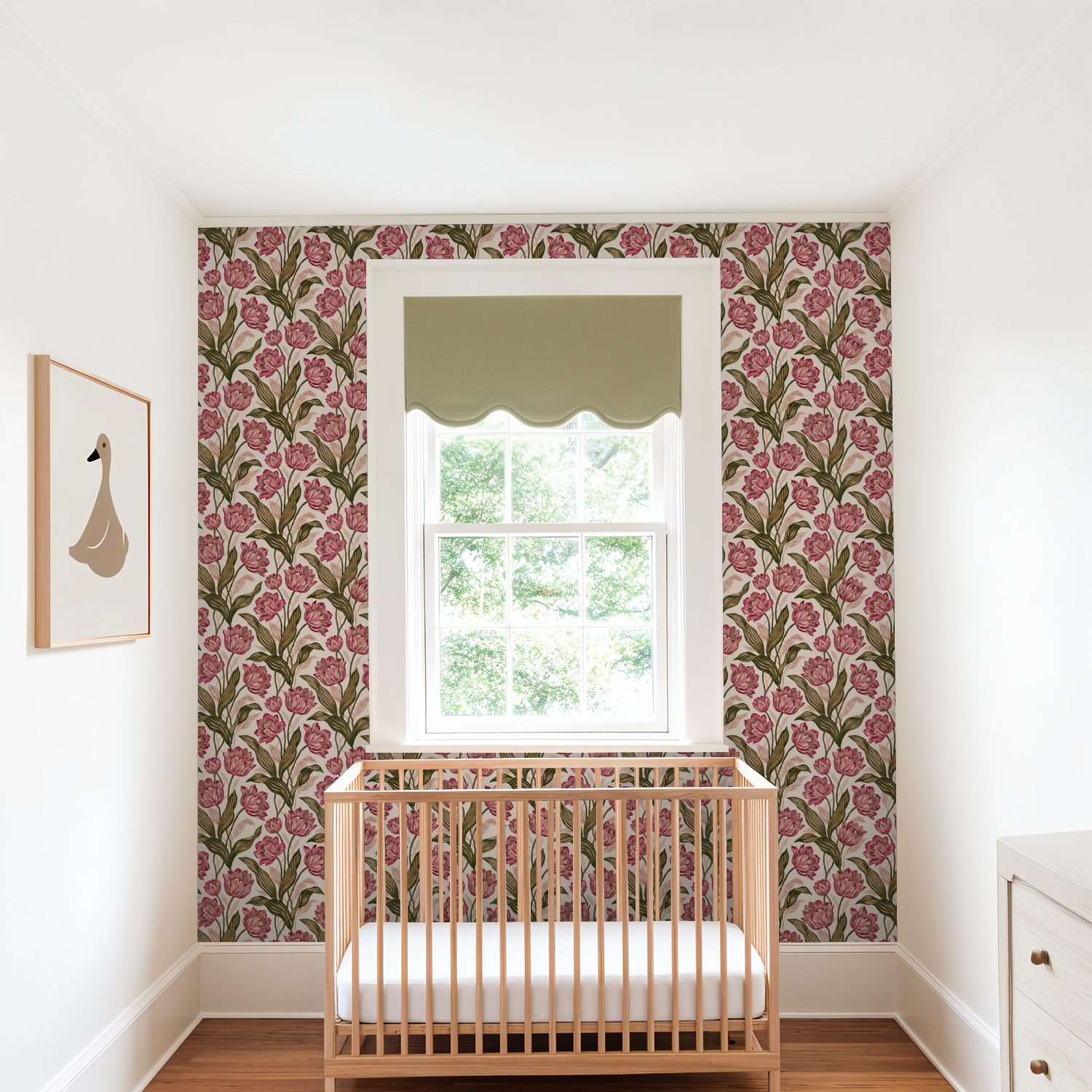 Nursery with pink floral wallpaper and wooden crib under window.