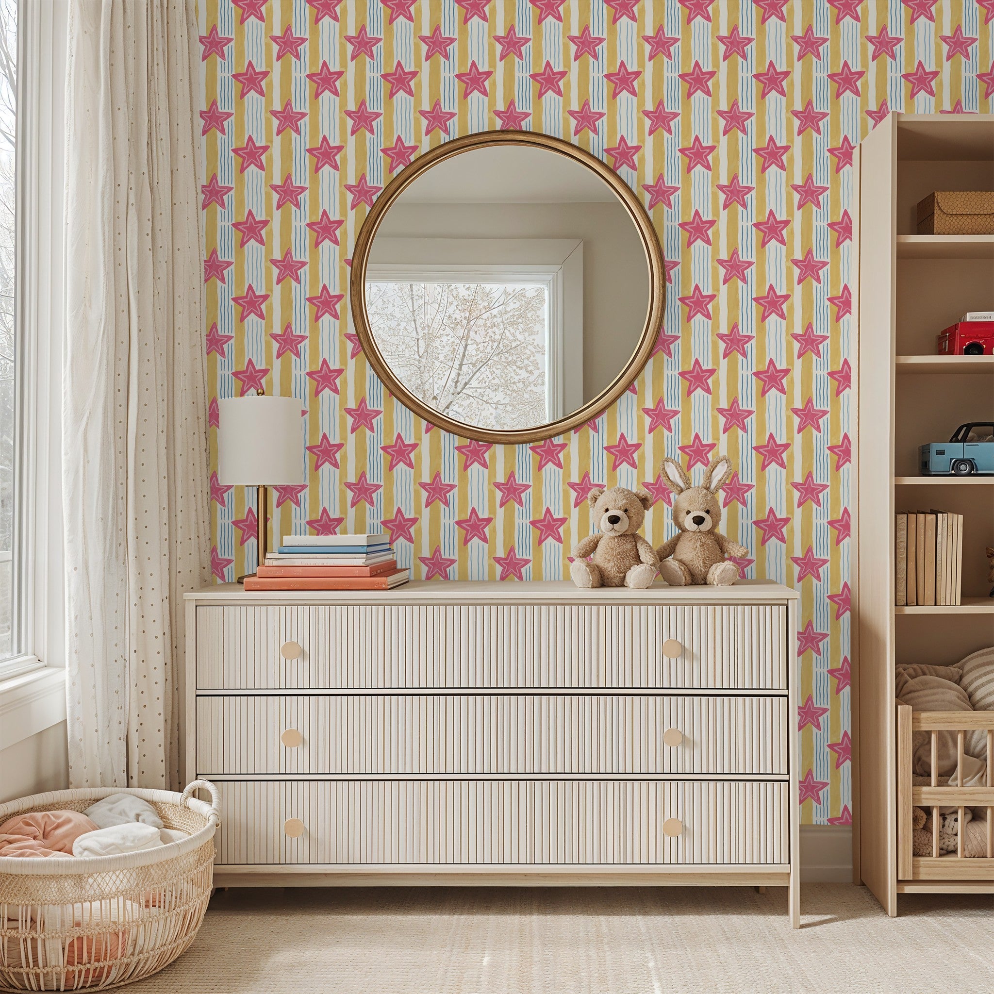 Pink star wallpaper with yellow and blue stripes in a cozy kid's bedroom.