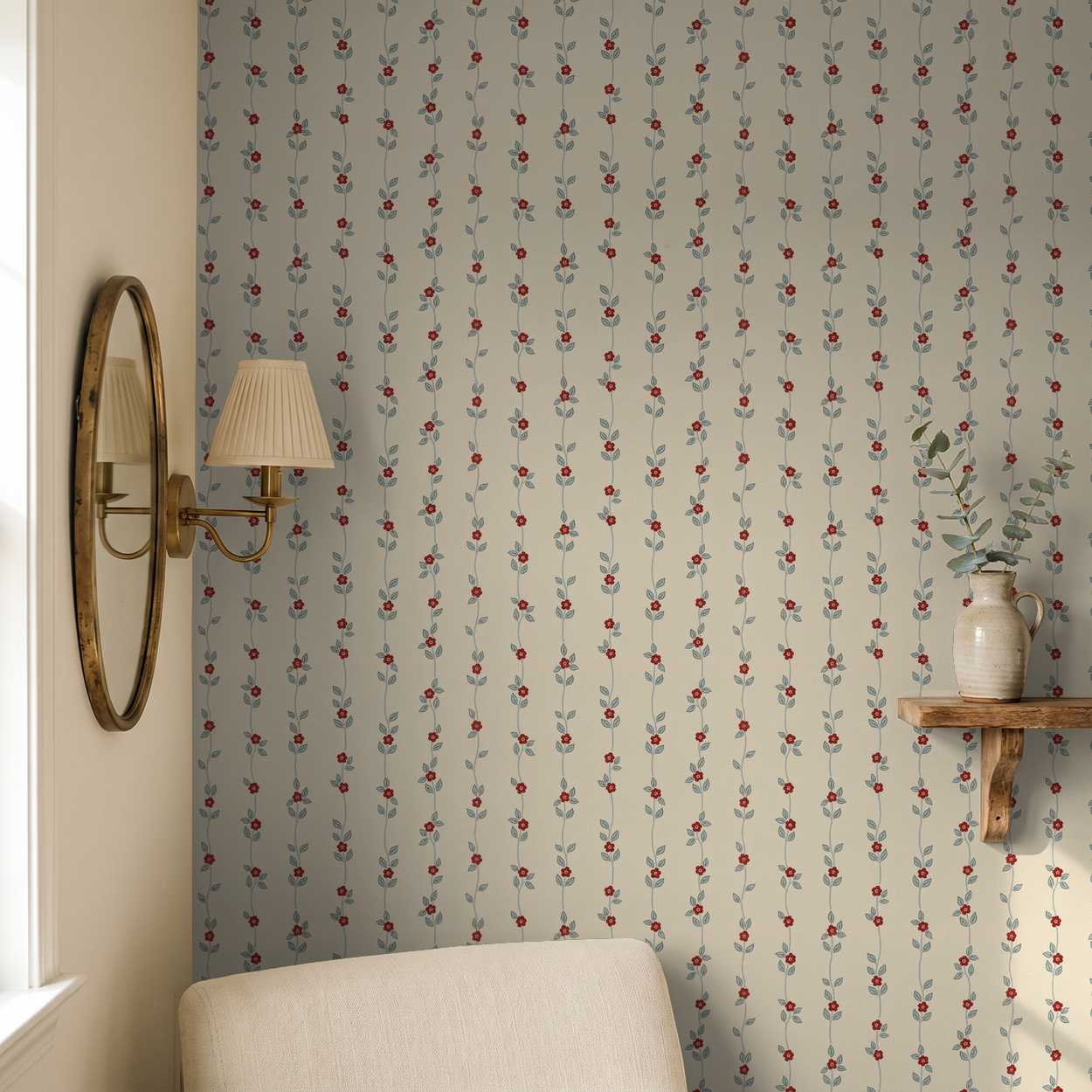 Cream wallpaper with red floral vine pattern in cozy room setting.
