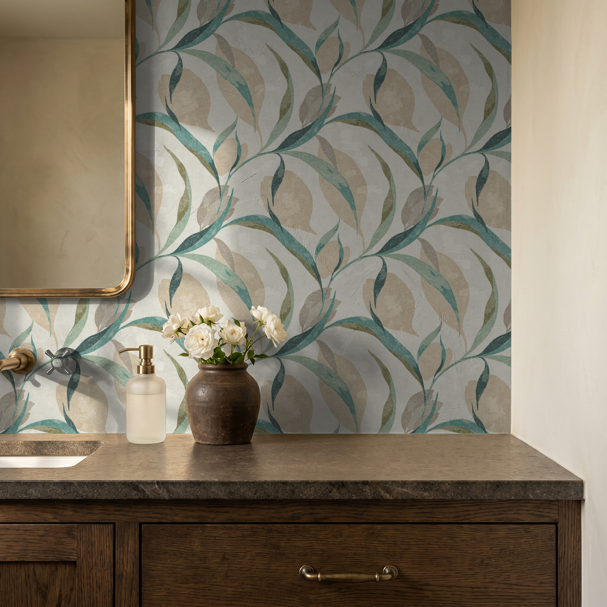 Teal and beige leaf pattern wallpaper in bathroom with wooden vanity.
