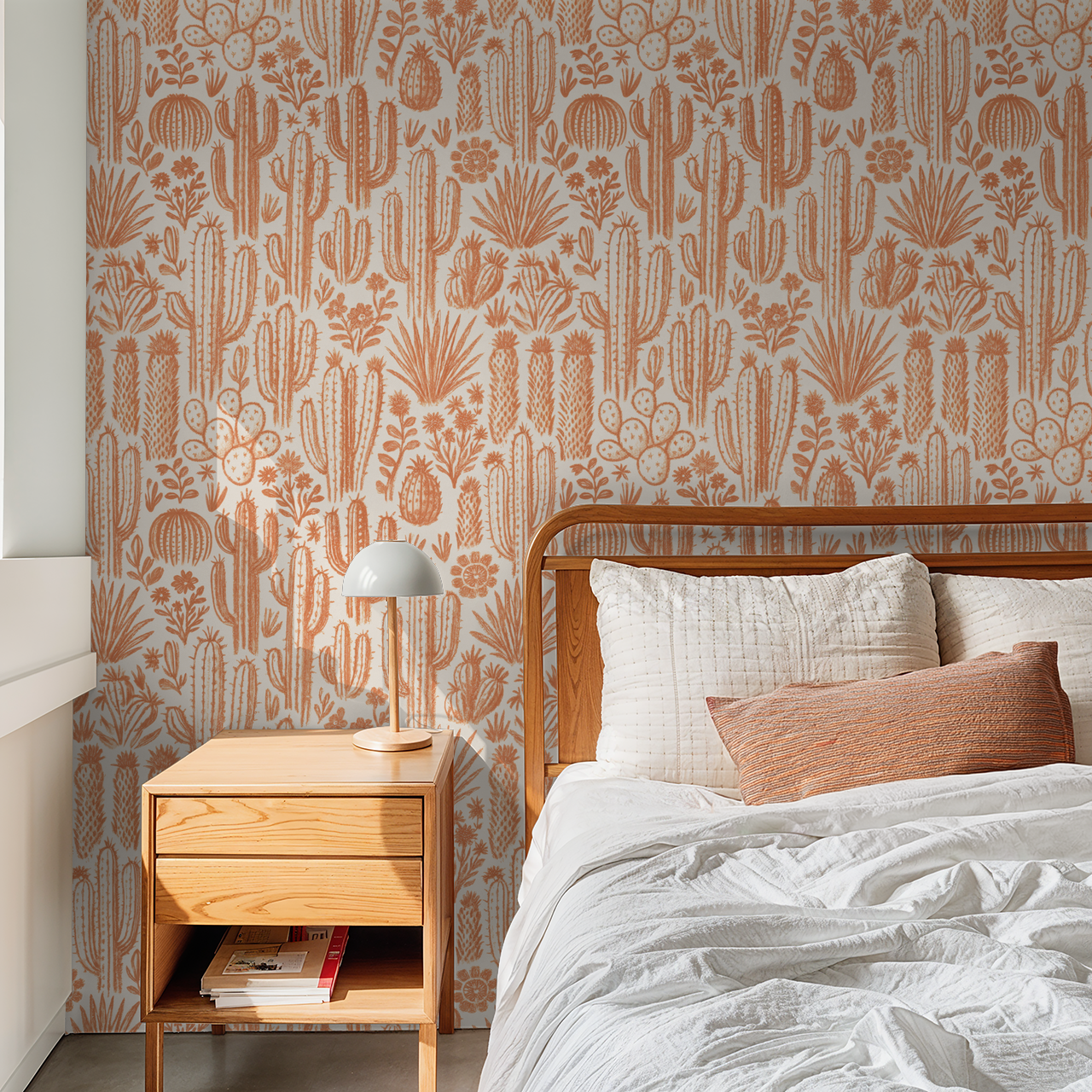 Terracotta cactus and floral wallpaper in cozy bedroom with wooden furniture.