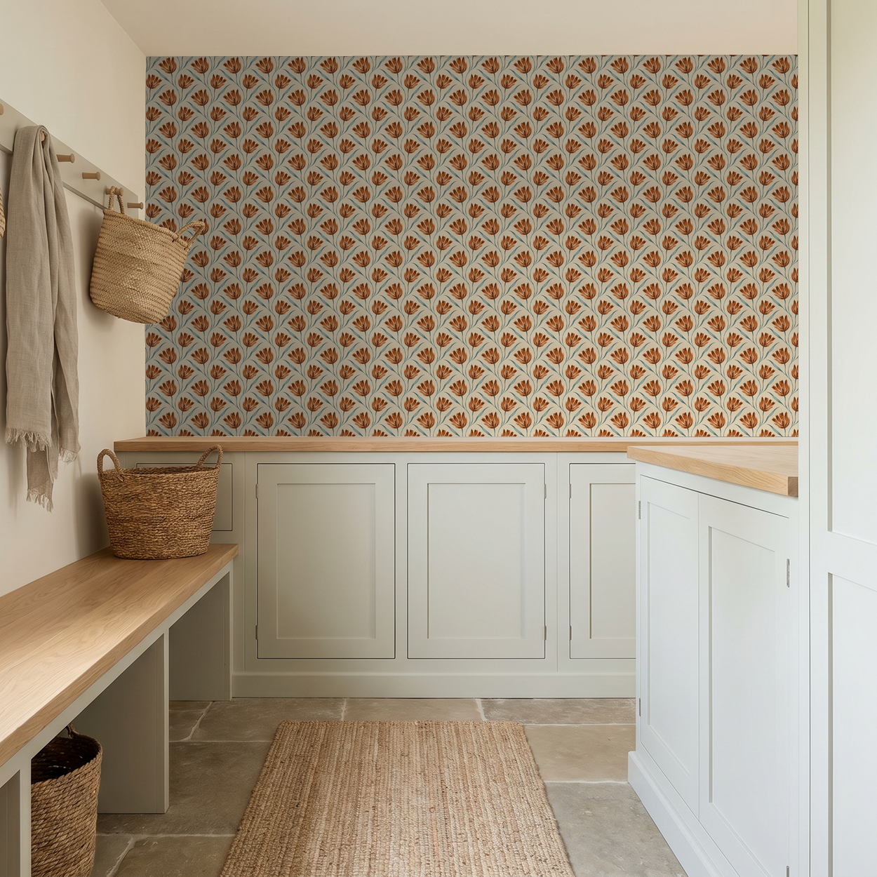 Terracotta floral wallpaper in a cozy mudroom with woven baskets and cream cabinets.