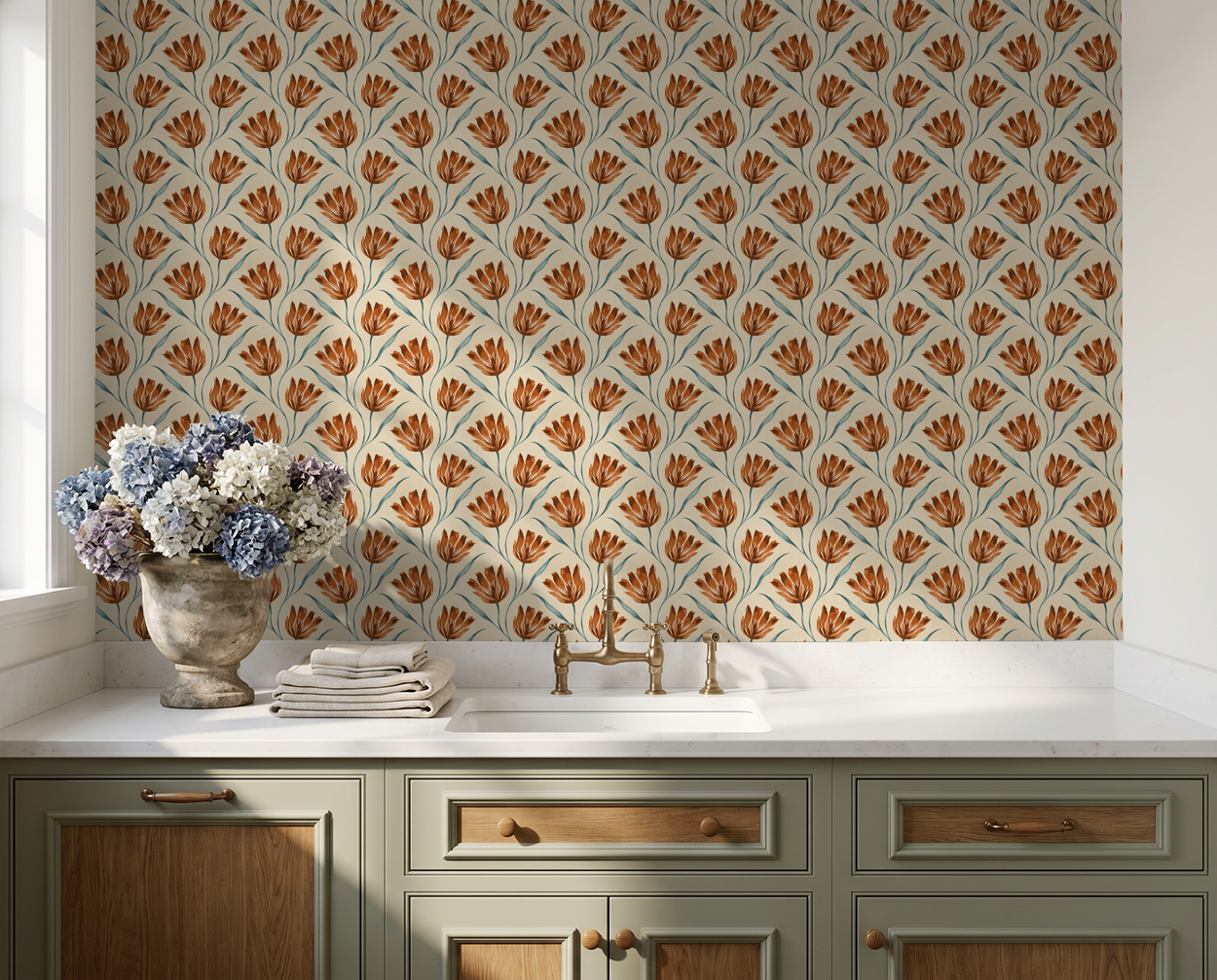 Terracotta floral wallpaper in kitchen with cream and green cabinets.