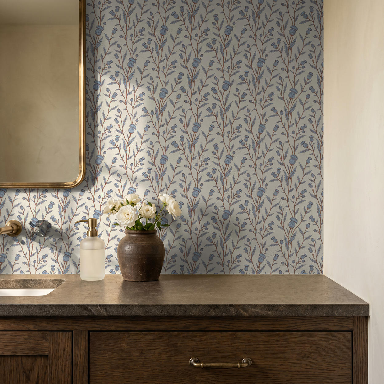 Thistle motif wallpaper in blue and brown in a rustic bathroom setting.