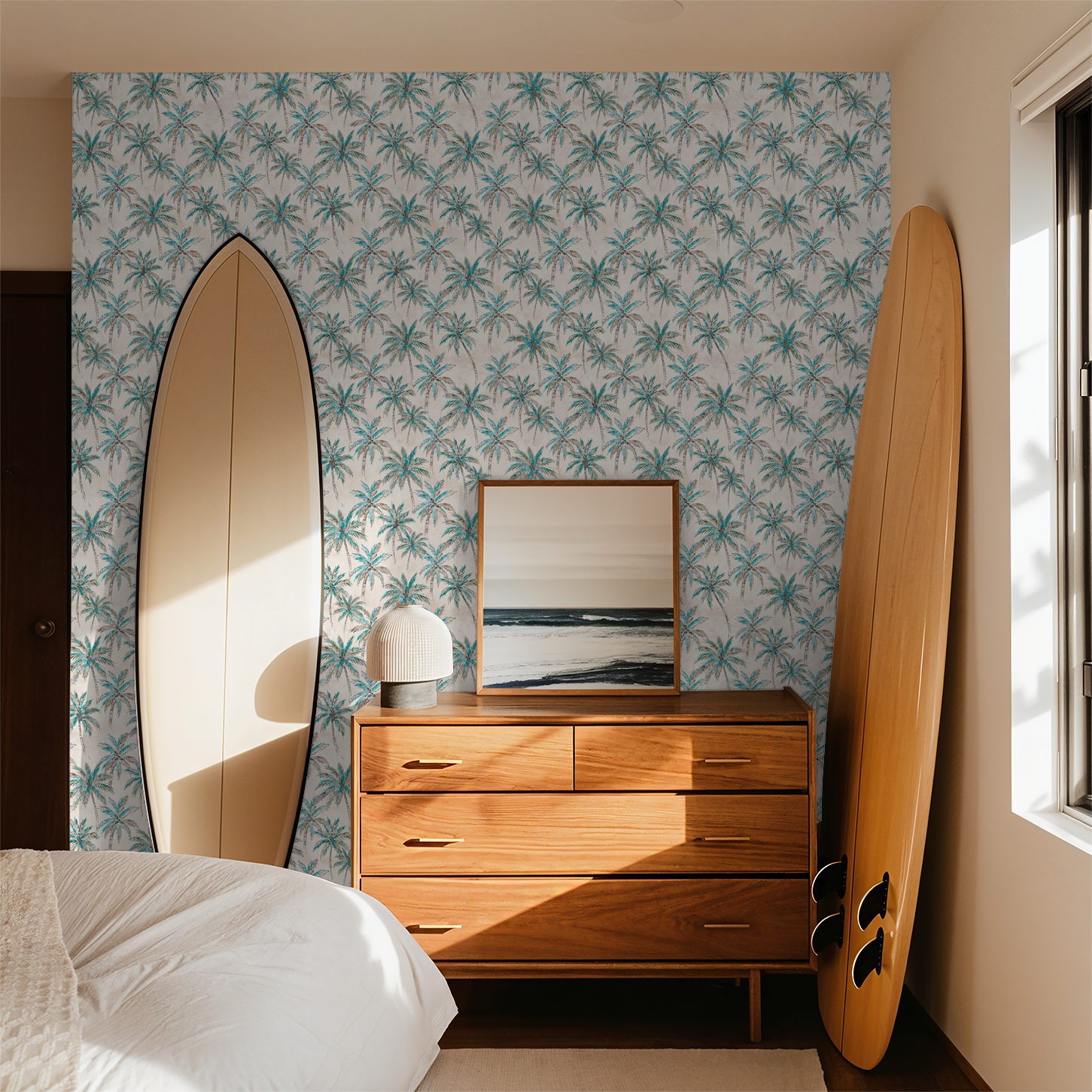 Tropical palm tree wallpaper in bedroom with surfboards and wooden dresser.