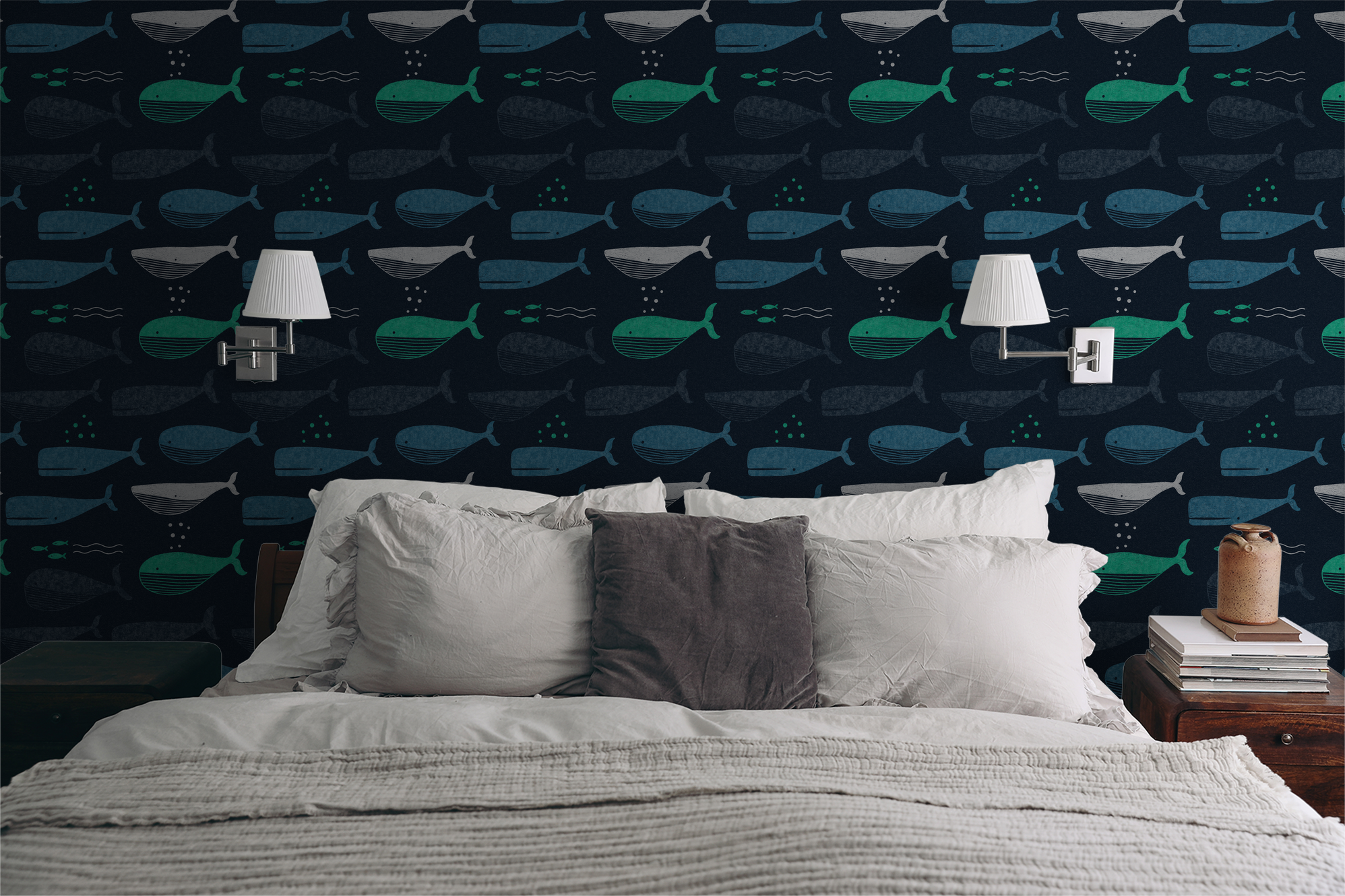Whale pattern wallpaper in navy with teal accents in a bedroom setting.
