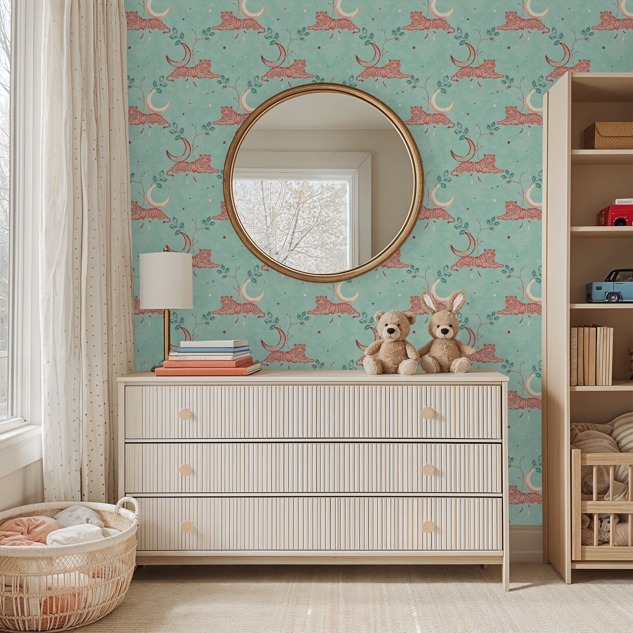 Whimsical tiger and moon wallpaper in aqua with coral accents in a cozy nursery.