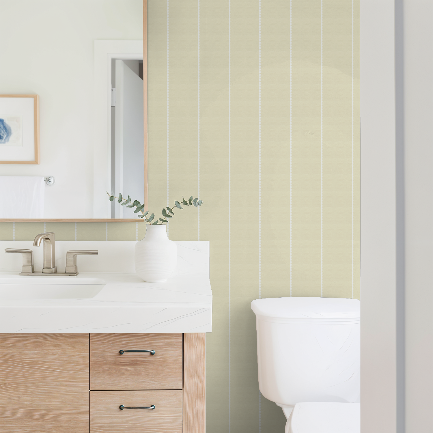 Yellow pinstripe dot wallpaper in modern bathroom with white sink and wooden cabinet.